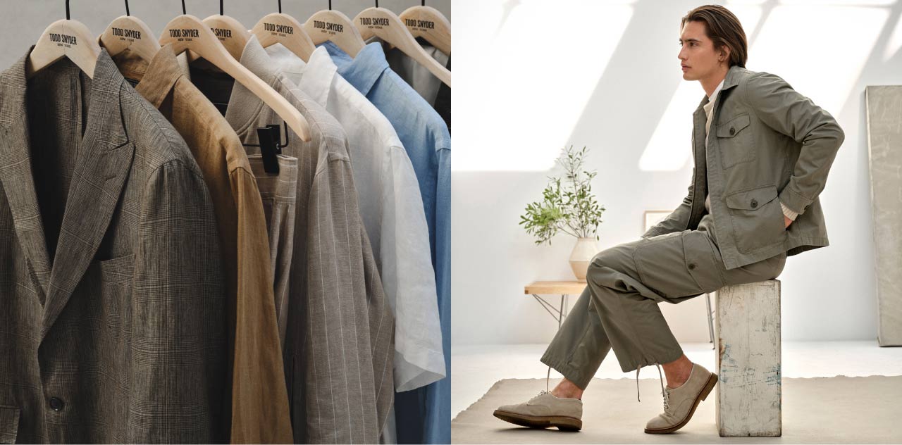 A photograph of sport coats, linen shirts, suits and other clothing in a row on hangers.