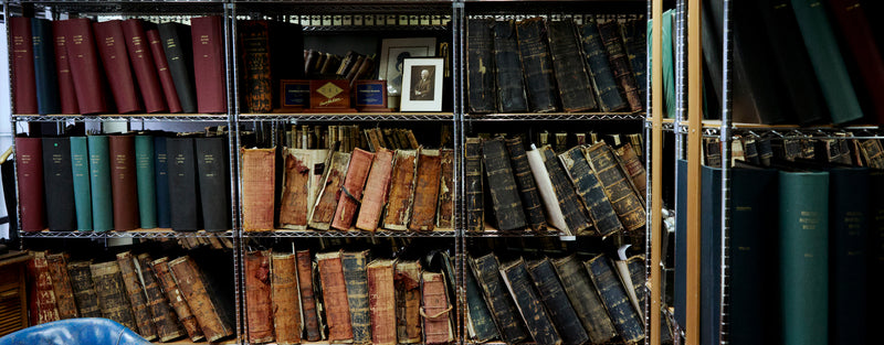 Antique leather bound books are on display.