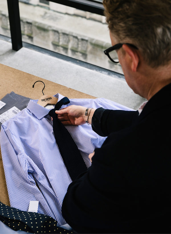 Todd Snyder is shown matching a striped shirt with a tie.