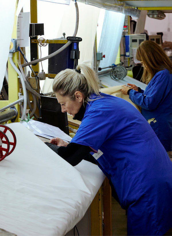 A craftsman is shown working on the production line.