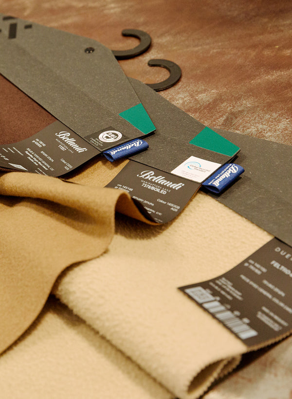 Swatches of textiles are shown in different natural colors (beige, brown, tan) that show their high quality.