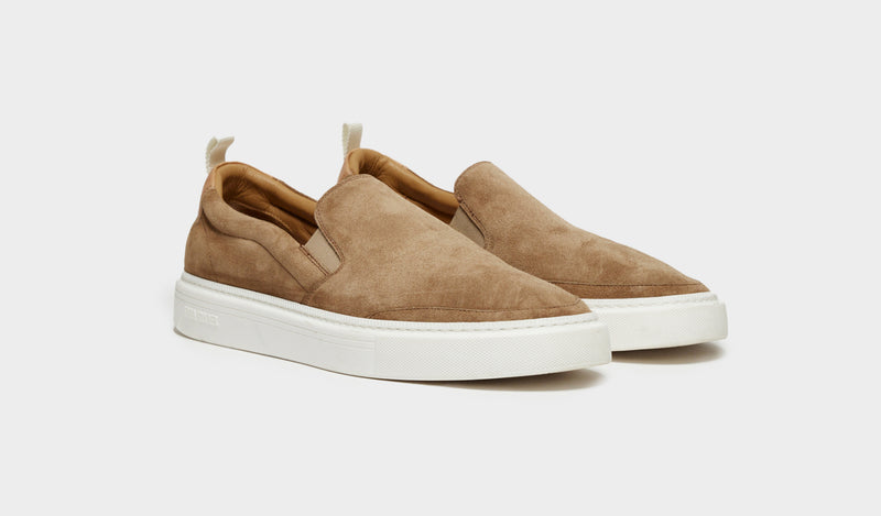 A black sneaker is shown with both leather and suede craftmanship.