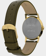 Timex watch with green strap and gold case on a white background